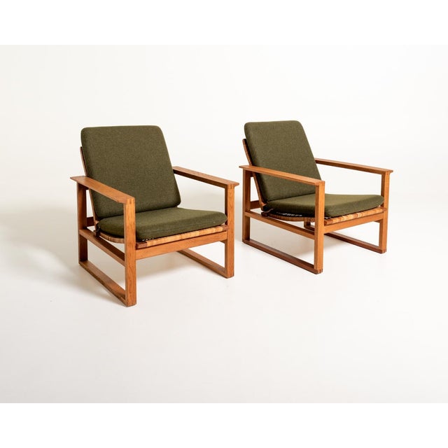 Model 2254, in oak and woven rattan, with original removable cushion covers in olive green wool. Børge Mogensen for...