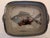 A hand-crafted rectangular pottery serving dish with a colorful fish design in rich blues and tans. Made in South Africa....