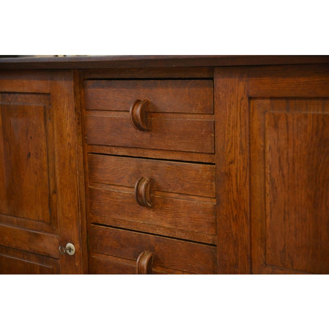 A typical oak sideboard from the Reconstruction period, with a restrained yet highly structured aesthetic. Its balanced...