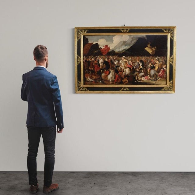 An important flemish painting from the first half of the 17th century. This oil on panel artwork depicts a battle between...