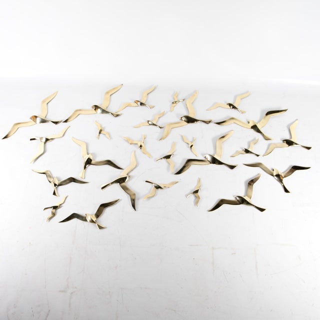 Rare set of 25 polished brass wall sculptures depicting birds. Each has a hook on the back for wall mounting. This highly...