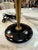 Elegant vintage Mid-Century Modern table lamp featuring a sleek black metal dome shade, tapered brass stem, and matching...