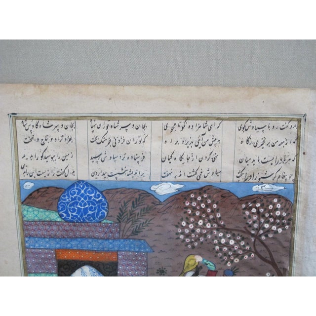 Beautiful antique Persian illuminated manuscript page with script and a finely detailed painting in bright colors showing...