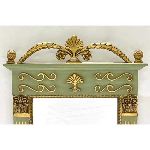 A mid-20th century modern French decorative painted wood trumeau mirror, in an Empire revival design, decorated in a...