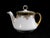 This is a white porcelain covered creamer (or small teapot) by MZ Austria. It has black bands at the rim, multi-color...