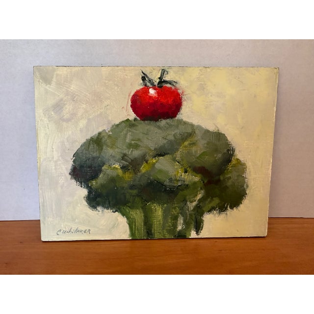 Small oil painting of broccoli and tomato. Rich colors and amusing combination. Painting by Maine Artist Carolyn Whitaker.