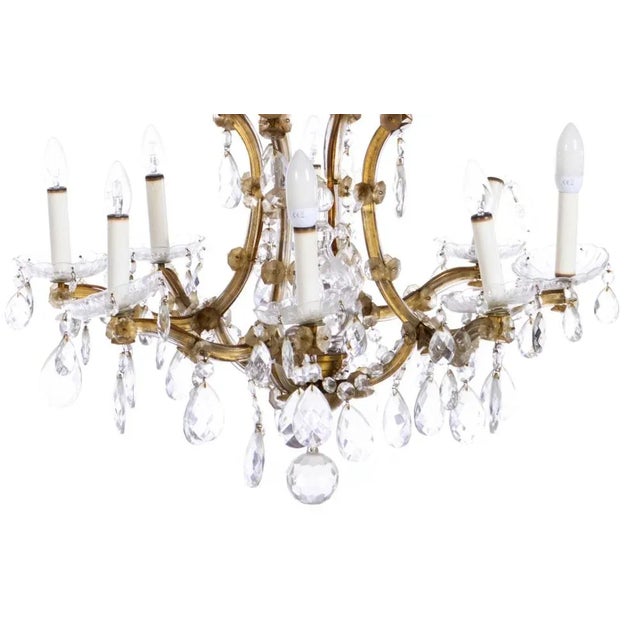 Nine light chandelier Lighting Category 20th century Portuguese, gilded metal structure, crystal drops and pendants....