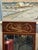 Elegant Empire-style wall mirror crafted in richly figured mahogany with a molded frame and an ornate brass ormolu crest...