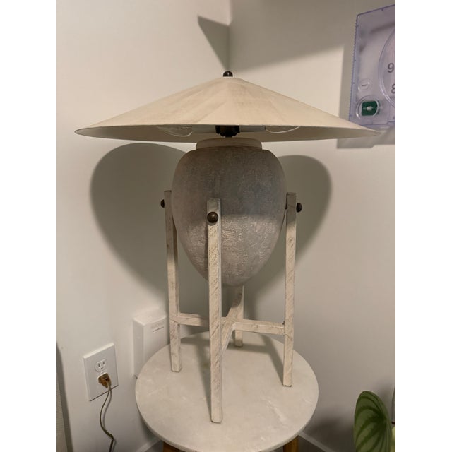 Iconic 1980s table lamp designed by Max Blumberg, featuring a sculptural urn-form body suspended within an architectural...