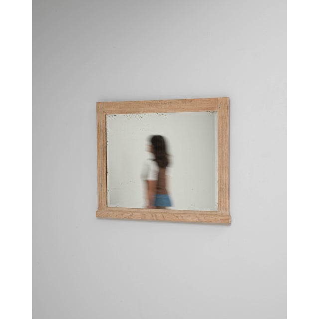 This 1900s French oak mirror presents a clean, understated silhouette that highlights the natural beauty of its materials....