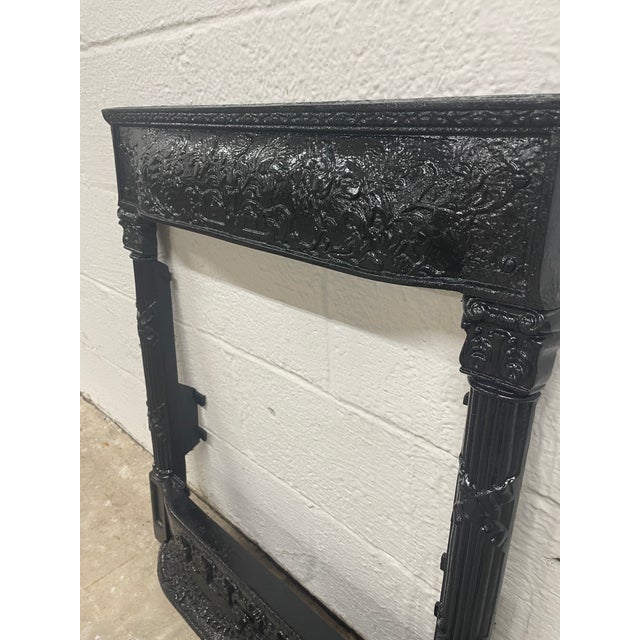 A stunning showcase of high-Victorian luxury and architectural elegance. This antique 19th-century cast iron fireplace...