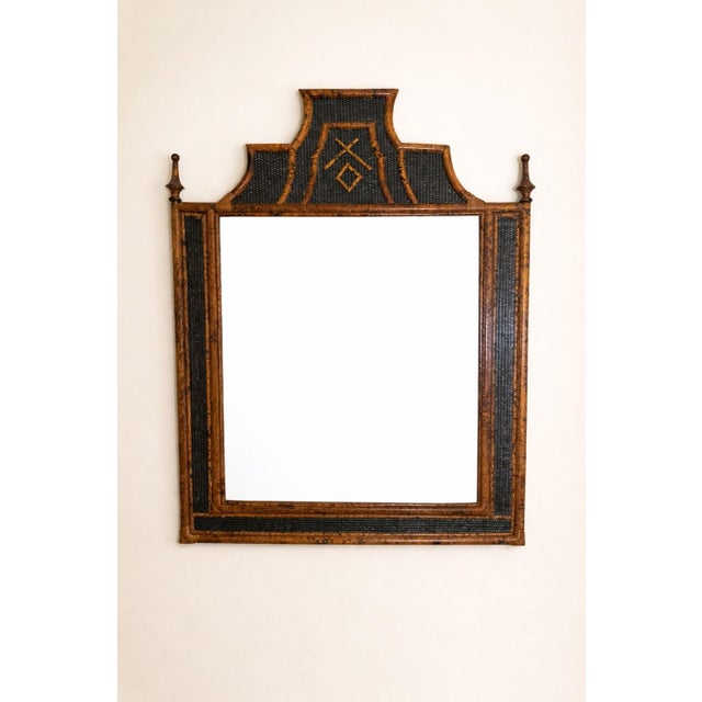 A monumental British Colonial faux bamboo pagoda mirror featuring woven rattan inset panels and a dramatic stepped...