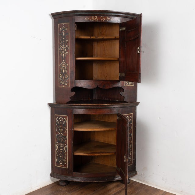This original brown painted corner cabinet is an excellent example of Swedish country craftsmanship with traditional folk...