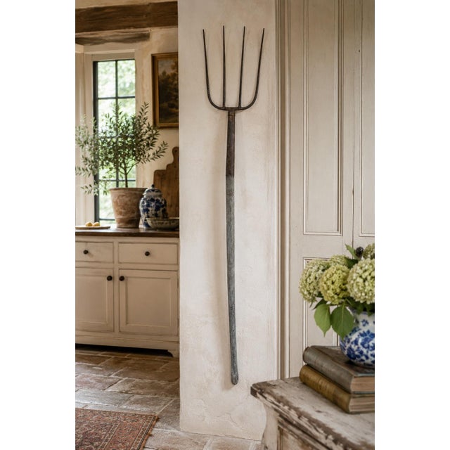 A wonderfully sculptural early 20th century wooden and iron pitchfork garden tool, with a beautifully weathered surface...