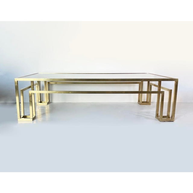 Elegant 1970s vintage coffee table made entirely of brass with a smoked glass top. Dimensions: L 130 x D 80 x H 35 cm...