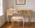 A charming vintage vanity and matching bench designed by Ralph H. Widdicombe for the John Widdicomb Company of Grand...