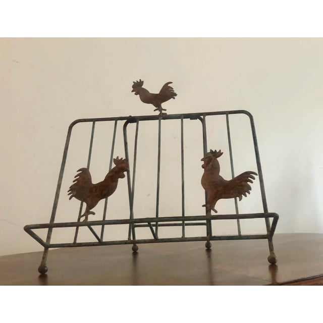 Rustic book holder featuring three chickens on rusted, patinaed metal. Structurally sturdy and aesthetically pleasing
