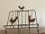 Rustic book holder featuring three chickens on rusted, patinaed metal. Structurally sturdy and aesthetically pleasing