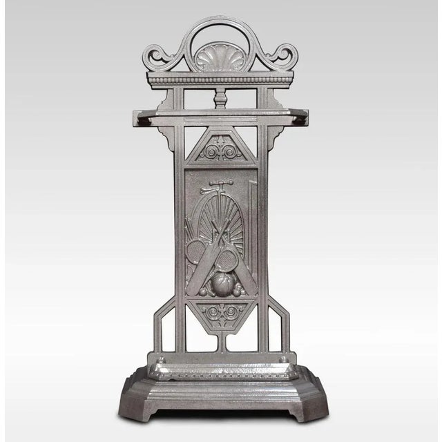19th century cast iron stick or umbrella stand, the back plate with sporting motif and penny farthing in background. All...