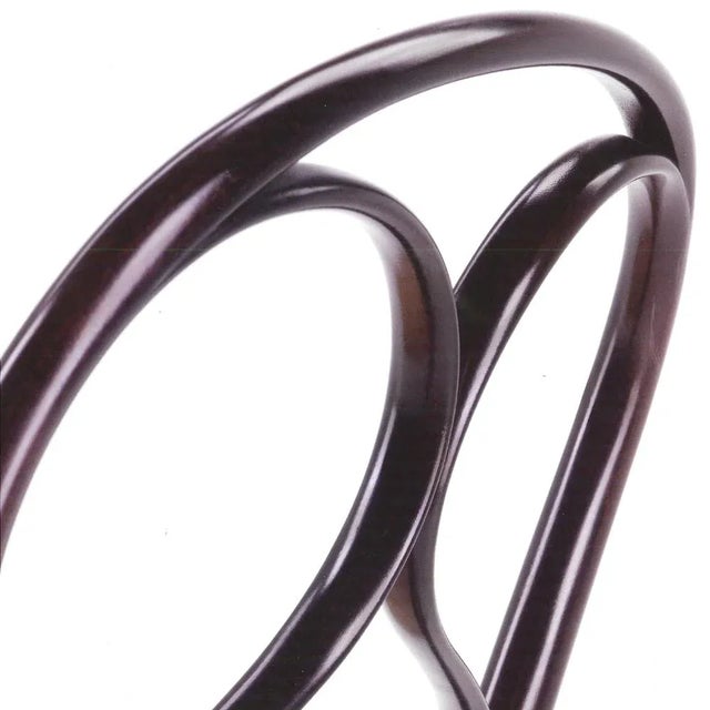 Chair in curved solid beech in dark walnut stained finish. Vienna straw seat. Tips in synthetic material. The name of the...