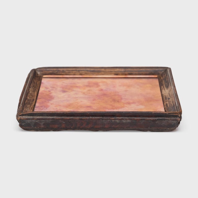 Simple lines, a modest form, and a well-worn finish give this small Qing-dynasty tray a provincial charm that recalls the...