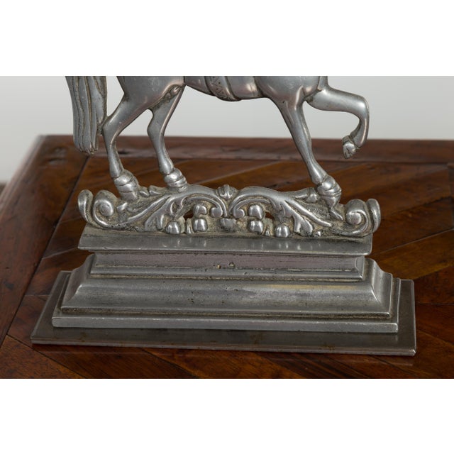 A pair of English silver toned metal prancing horses from the early 20th century, perfect to be used as bookends. Created...
