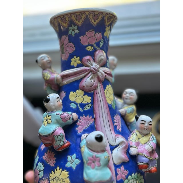 An exceptional and highly decorative vintage Chinese porcelain vase featuring the auspicious Seven Boys motif, rendered on...
