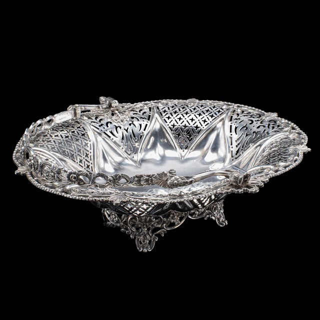 This is a vintage decorative cake basket. An English, silver plated table centrepiece or fruit dish, dating to the mid...
