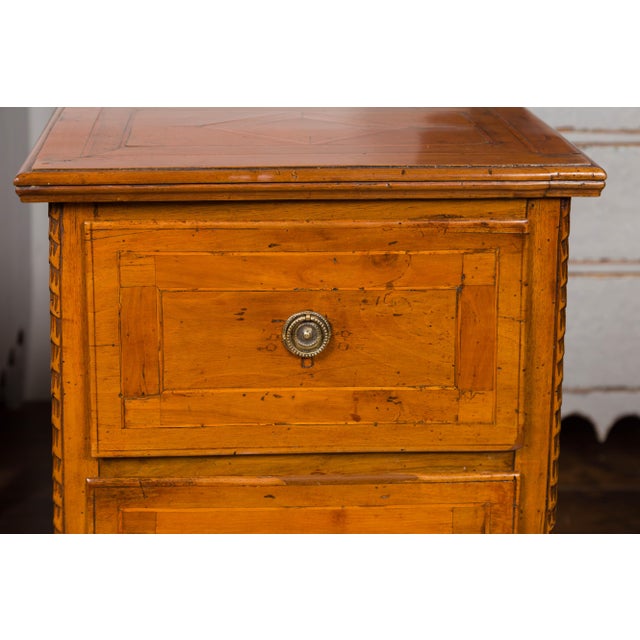 A pair of Italian neoclassical walnut bedside tables from the early 19th century, with banding and fluted tapering legs....