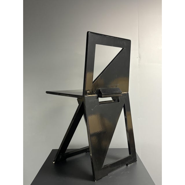 Striking foldable chair from the Eindhoven design academy circle, circa 1980s. Constructed from painted wood panels and...