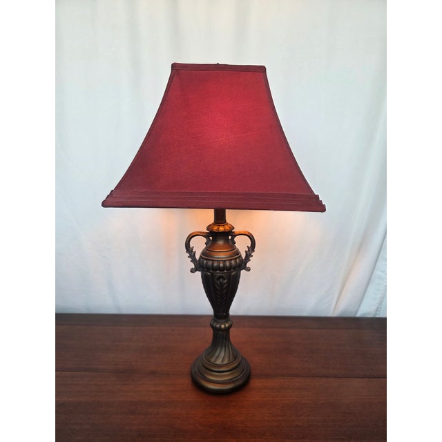 This vintage chalkware table lamp captures the dramatic elegance of mid-century Neoclassical Revival design, drawing...