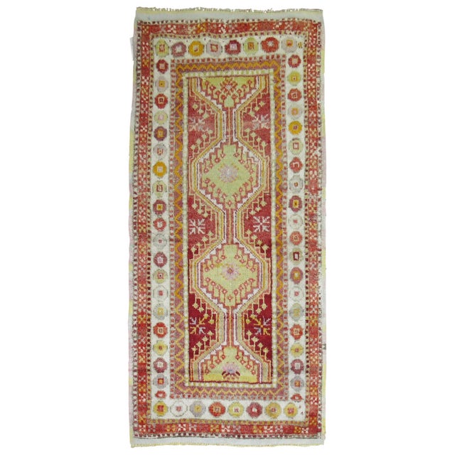 Mid 20th century tribal Turkish scatter size rug in bright red and green Measures: 2'8" x 5'4".