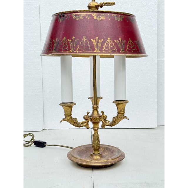 This elegant 19th-century French bouillotte lamp features a classic gilt bronze (ormolu) base with finely cast details and...