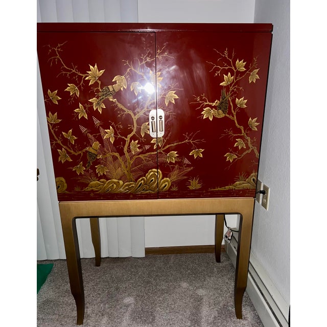 Bar cabinet with two doors that hold glassware storage on the inside of doors. . Single interior tray drawer with smoked...