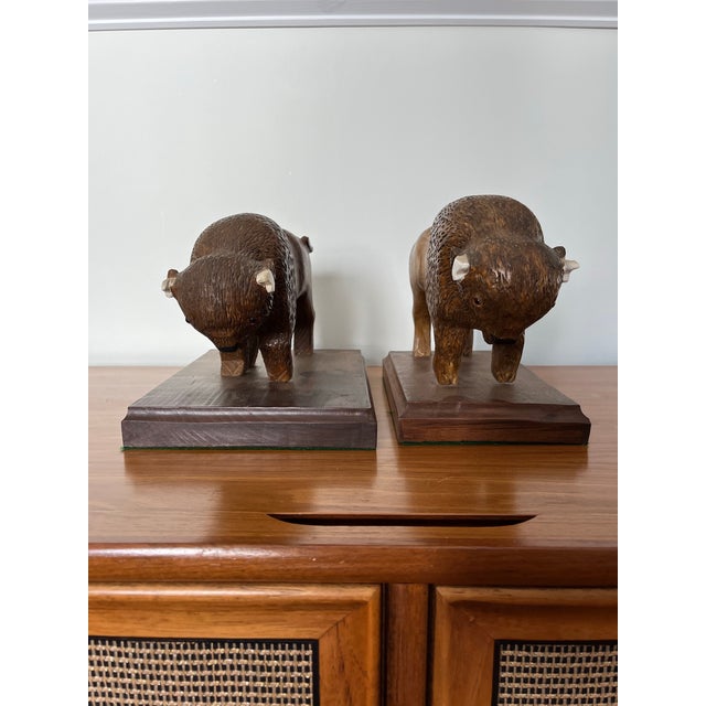 Fantastic pair of hand carved wooded buffalo or bison. Great detail and proportions. Slightly different in size. Signed SL...