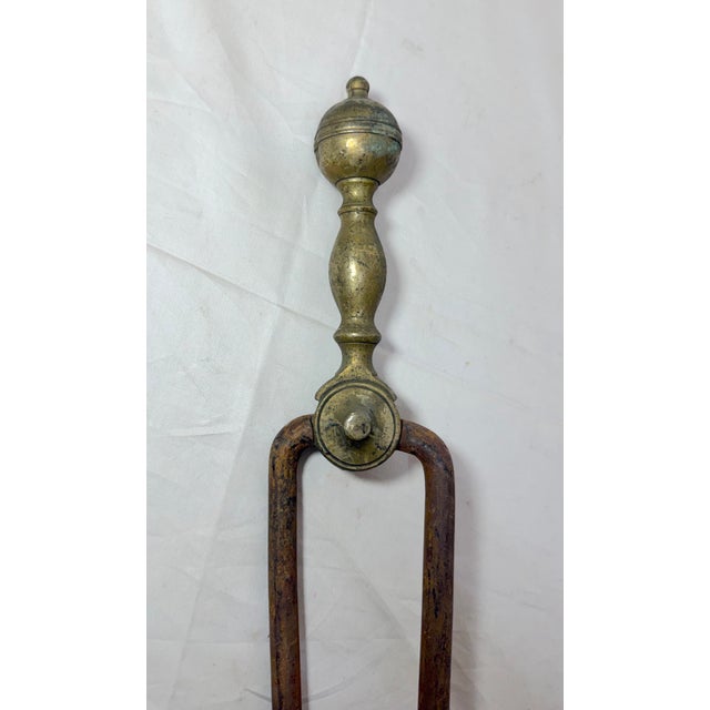 Up for sale is a nice pair of rare antique 18th century wrought iron and brass English fireplace tongs. The arms are...