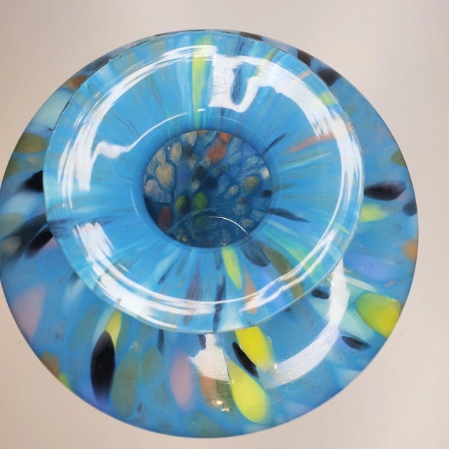 Add a touch of elegance to your space with this stunning 9-inch Italian art glass vase. Expertly hand-blown, this piece...