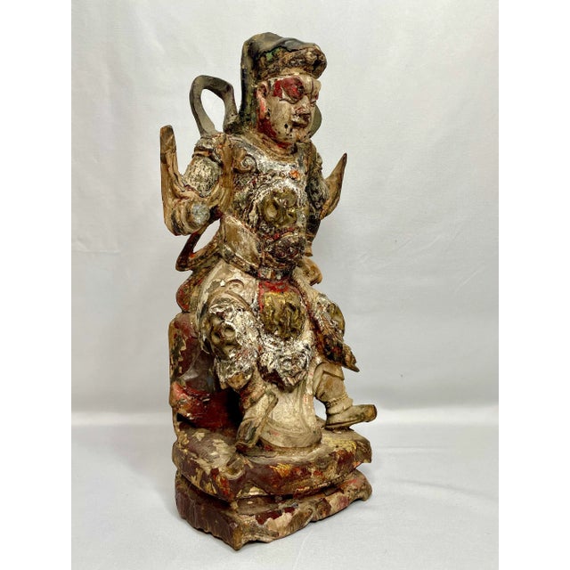A carved Guandi, or Chinese God of war circa late 15th early 16th century. Based on the historical figure Guan Yu who...