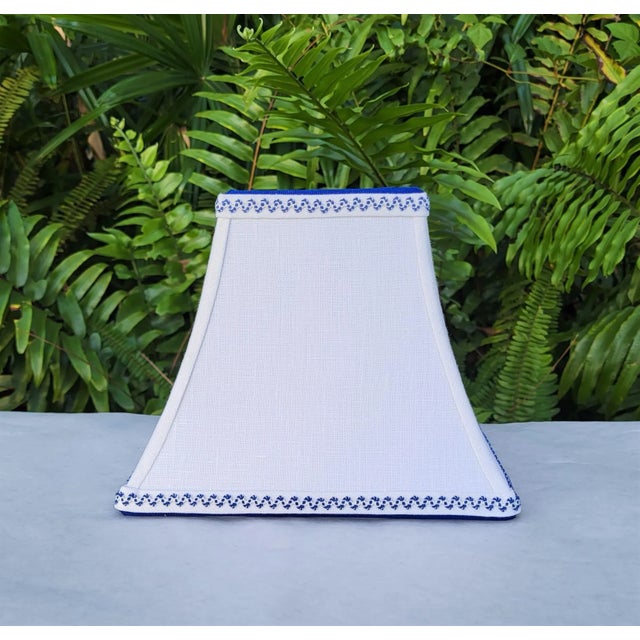 Fabric and Trim The shade base is lightweight crisp white linen. Top and bottom wiring is wrapped with nautical blue...