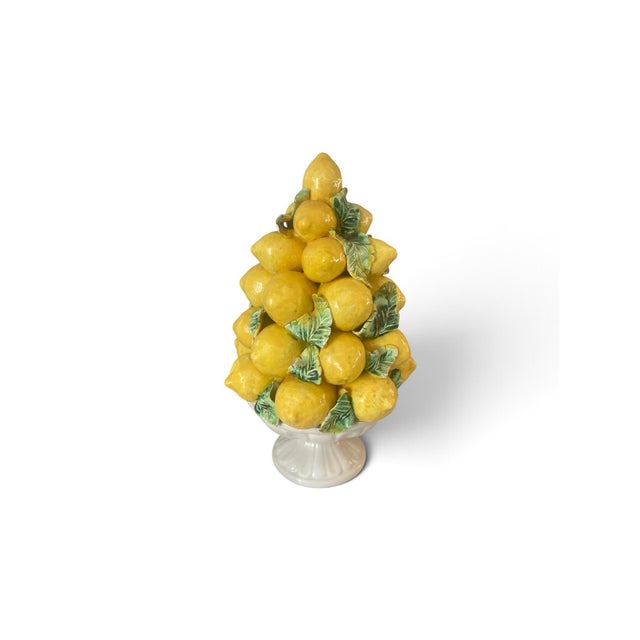 A charming, hand-crafted Italian ceramic topiary centerpiece featuring vibrant, high-gloss yellow lemons stacked in a...
