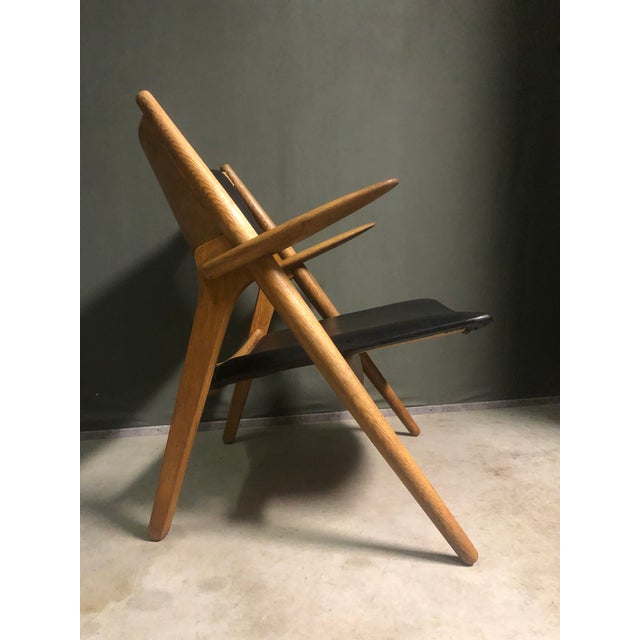 CH28 Sawbuck Lounge Chair by Hans Wegner for Carl Hansen & Søn, 1950s, in Flawless conditions. Designed 1950 to 1959 This...