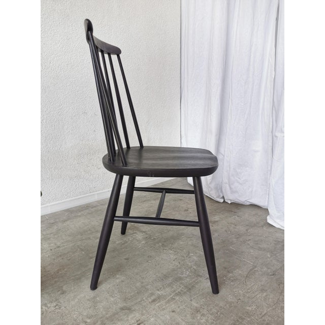 Vintage wooden dining chair in Ilmari Tapiovaara design. The chair is made from solid beech wood in black. Special...