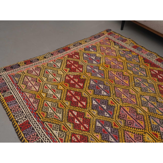 Vintage Hand-Knotted runner rug is a semi-antique vintage area rug. The '70s Eastern region of Anatolia's unique rug is...