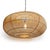 Handwoven pendant light made from finely split rattan with a low-profile silhouette that feels both airy and...
