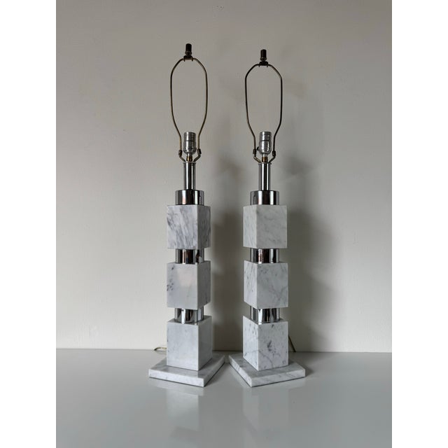This elegant pair of vintage Italian table lamps showcases a striking design featuring stacked white marble cubes...