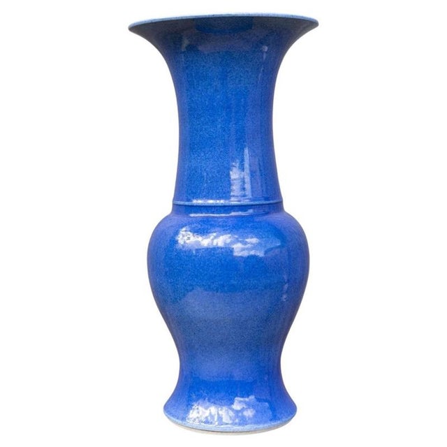 An elegant Chinese porcelain Yen Yen vase distinguished by its rich monochrome blue glaze and graceful traditional form....