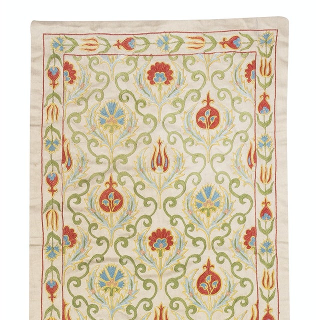 Celebrate the rich heritage of Asian craftsmanship with this exquisite 100% silk Suzani textile, meticulously hand-...