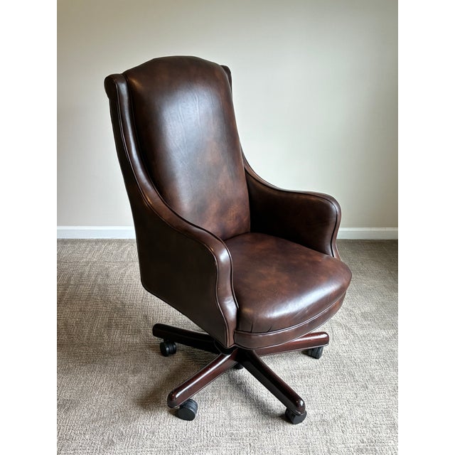 Exceptional Hancock & Moore “Dillon” swivel tilt chair upholstered in rich walnut brown leather with classic wingback...