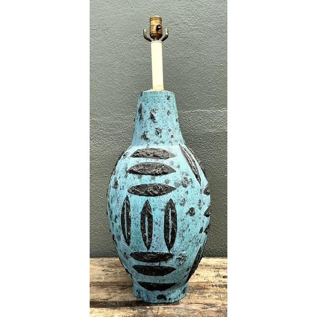 Infuse your home with the bold, experimental spirit of mid-century Italian studio pottery. This striking ceramic table...