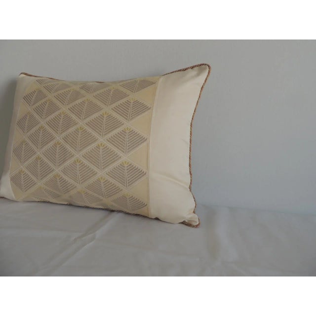 Woven gold obi front pattern Rope trim all around Golden silk backing Feather/down pillow insert Size: 15"H x 20"W